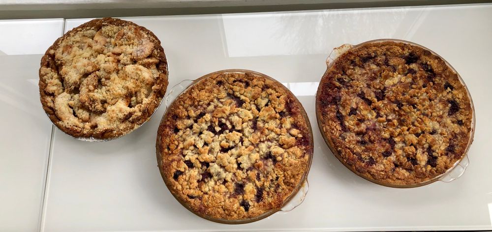 Three cherry pies. A bit singed, alas. Bottom crust with almond flour in it. Cherry filling. Crumb top crust with marzipan in it.
