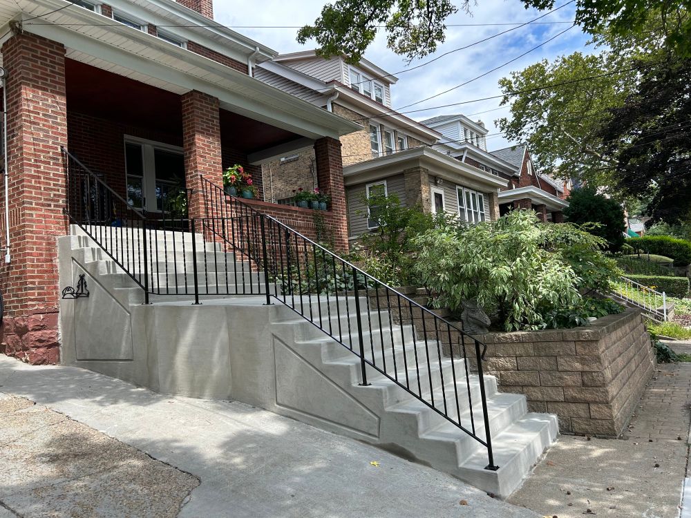 The new steps and new iron railing. That retaining wall is poured concrete with rebar.