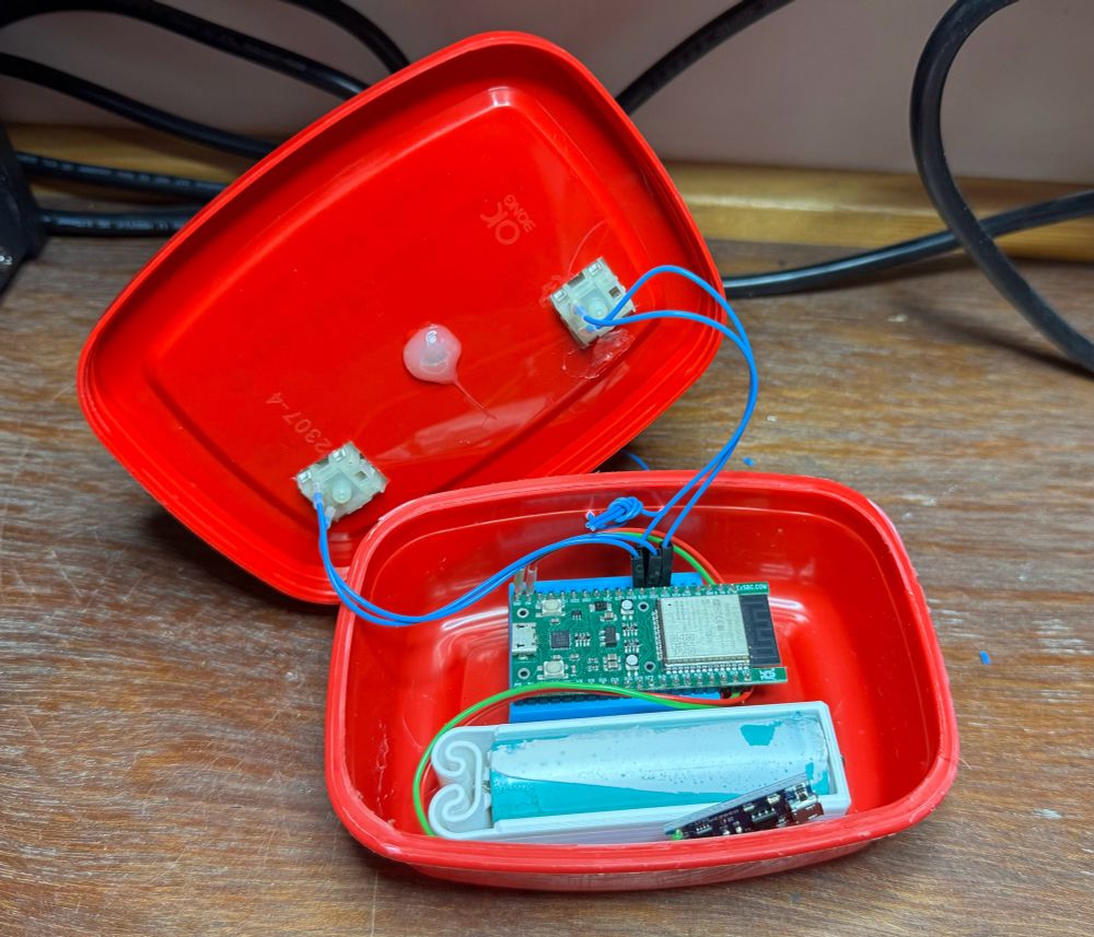 The inside of a DIY device consisting of an ESP32 board, a recycled 18650 cell, 3D printed cell holder, and switches