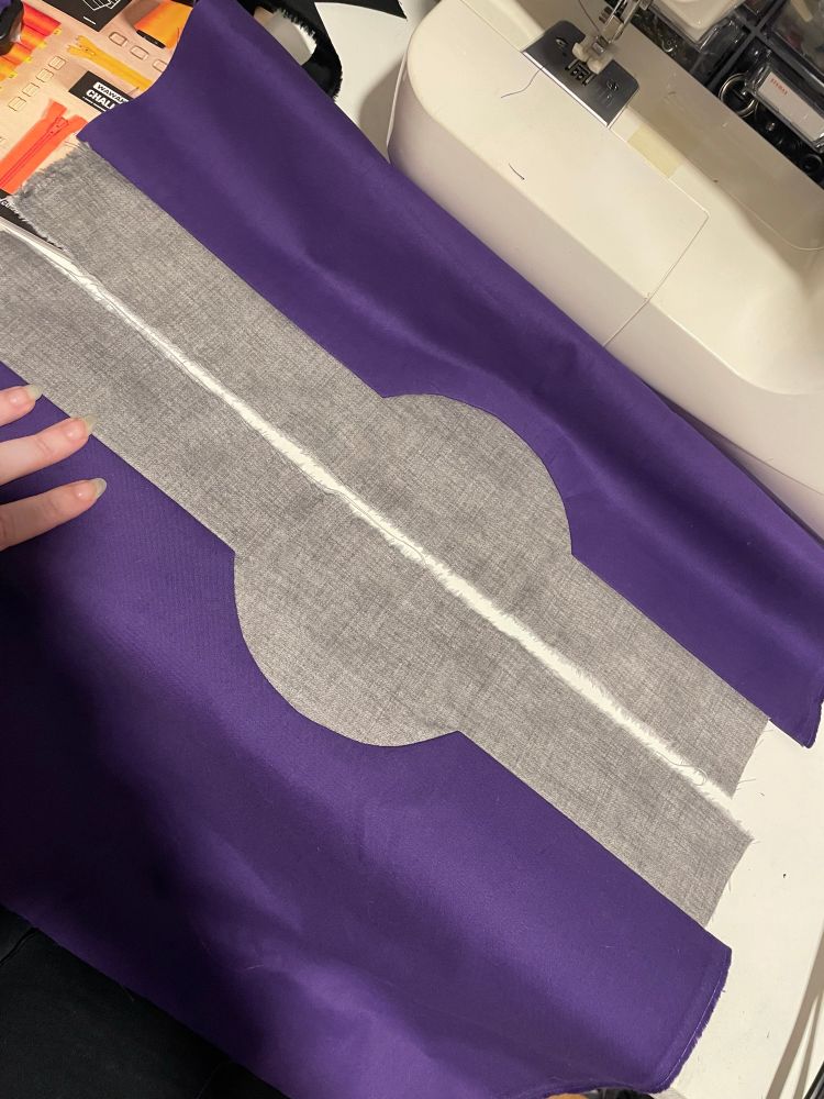 Grey fabric semicircles inset in purple fabric