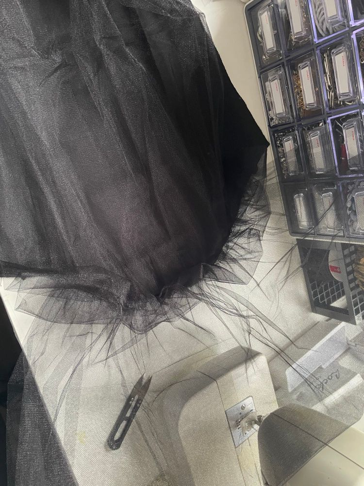 A black sleeve with gathered layers of black tulle attached