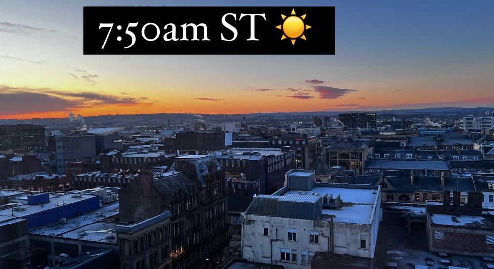 Image of a city during the sunrise. Buildings are clearly visible. This would be November time 7:50am during standard time. 