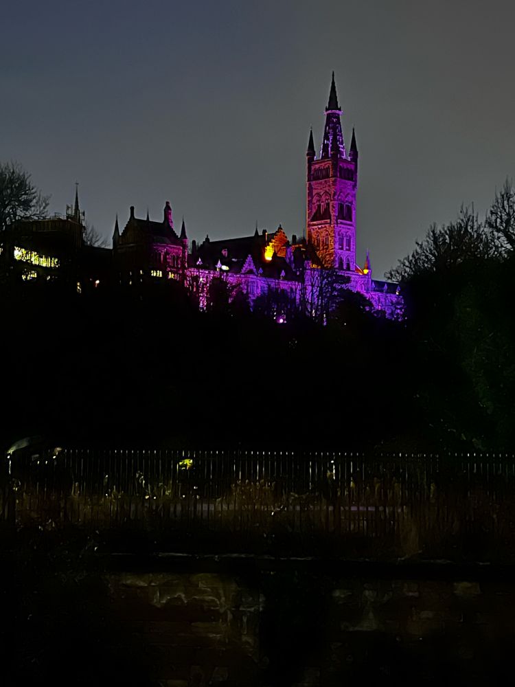 Glasgow university lit up in purple lights 
