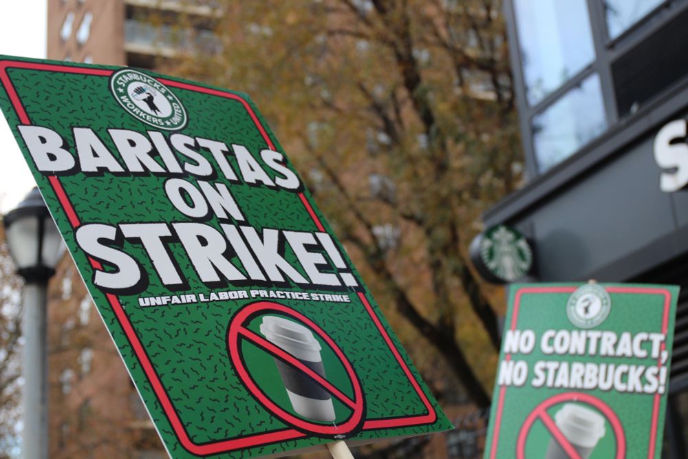 Signage reading "Baristas on Strike!" and "No Contract, No Starbucks!"