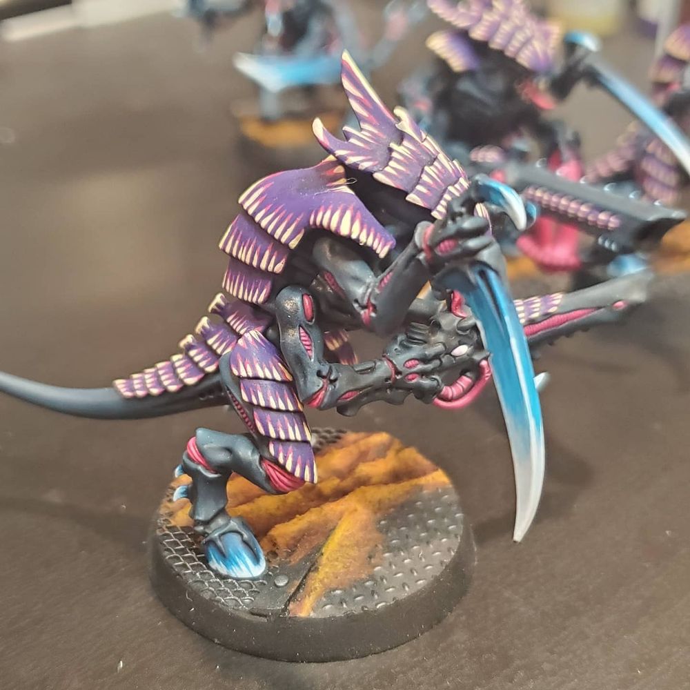 A six-limbed, armored beast stands upright on hooved feet, wielding a long barreled organic rifle in it's middle arms, and threatening the immediate vicinity with razor sharp man-sized talons in its topmost arms