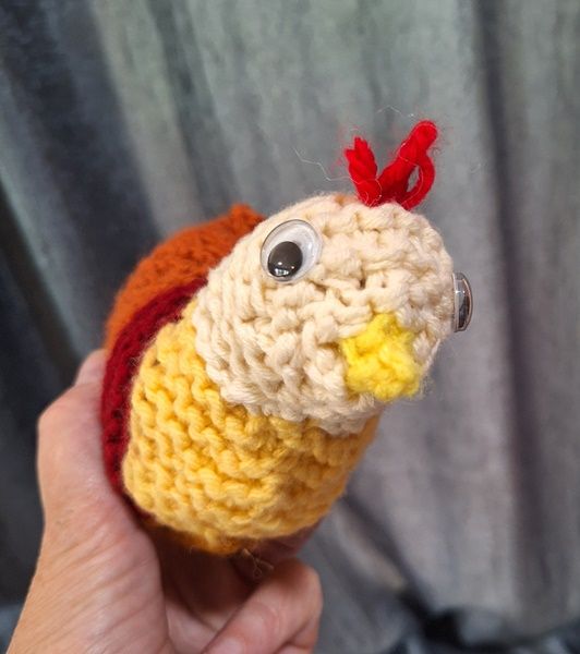 Knit toy chicken staring at you encouragingly with her googly eyes. 