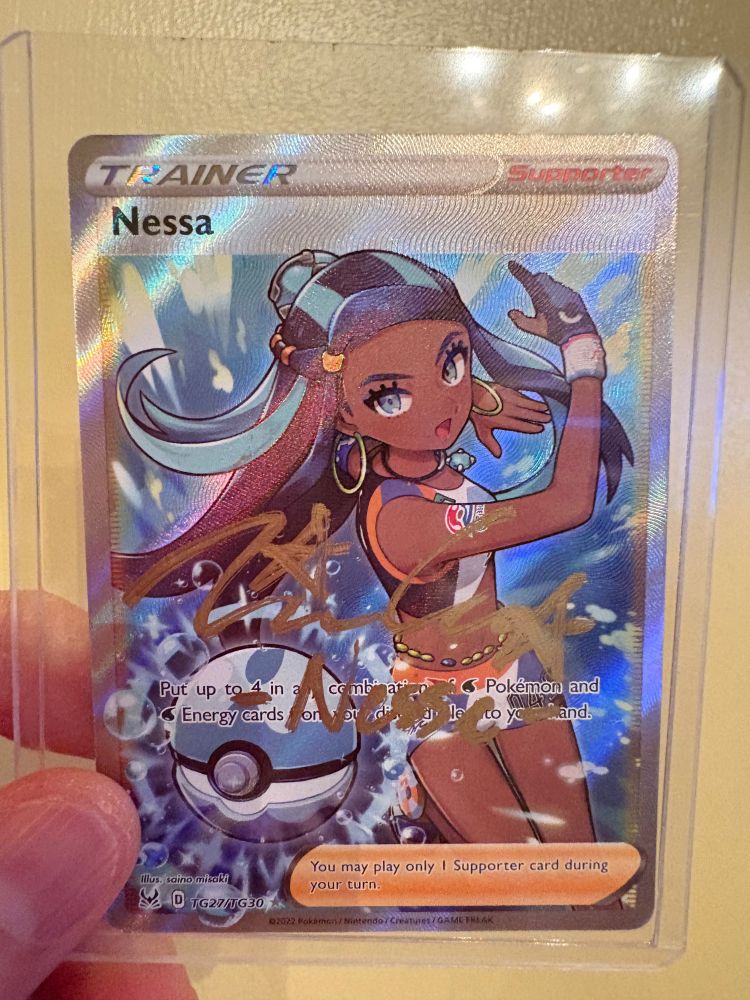 Pokemon card of Nessa signed by Tiana Camacho featuring Nessa slinging her blue Pokeball.