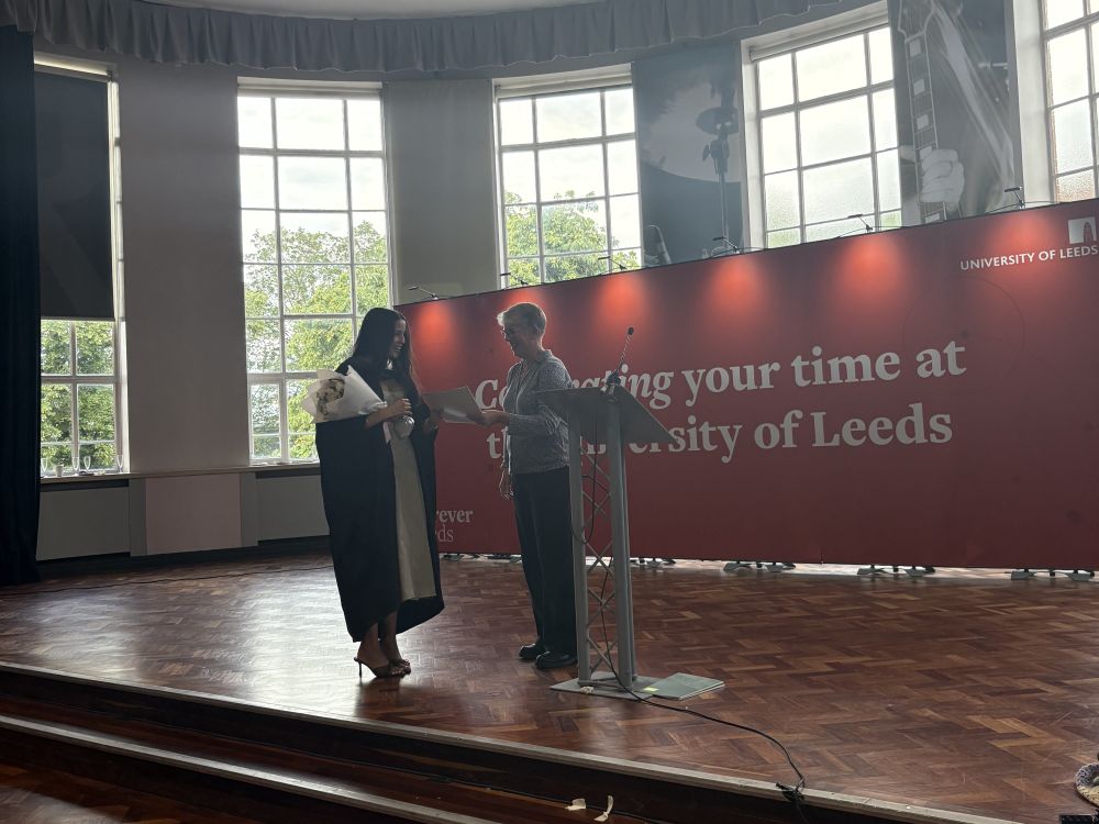 Student receiving prize certificate from Head of School