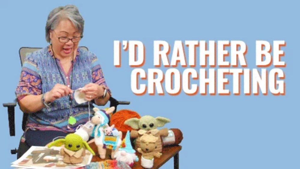 a woman is sitting at a table with stuffed animals and the words i 'd rather be crocheting behind her