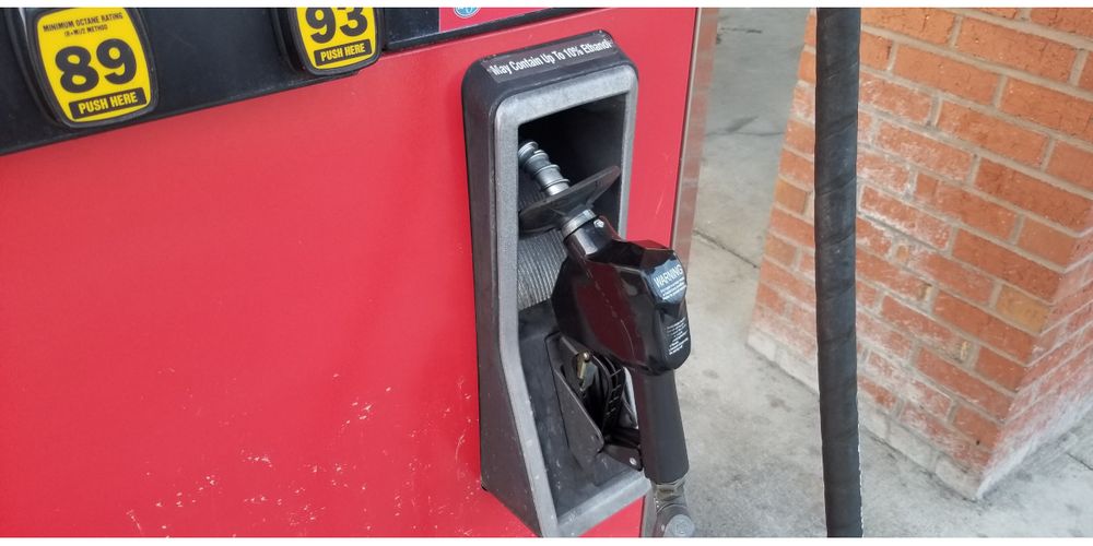Closeup of gas pump handle in cradle