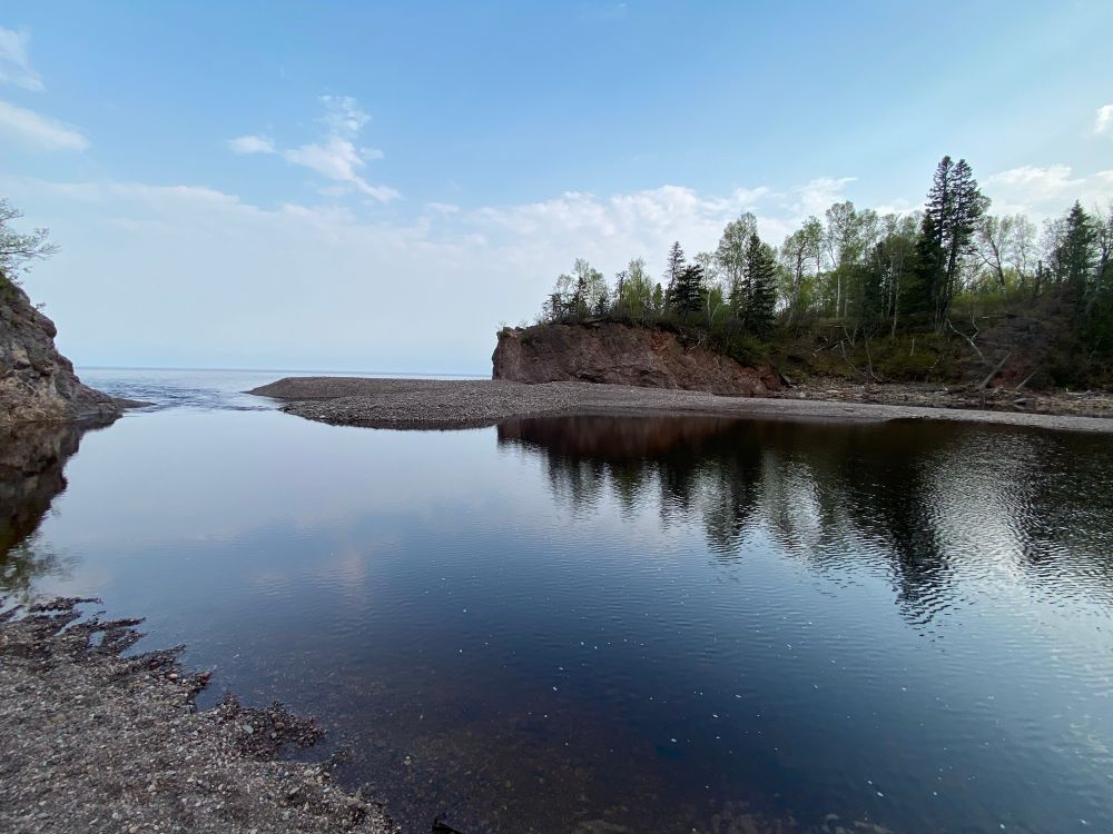 Baptism river meets Lake Superior, with a smoggy horizon line.