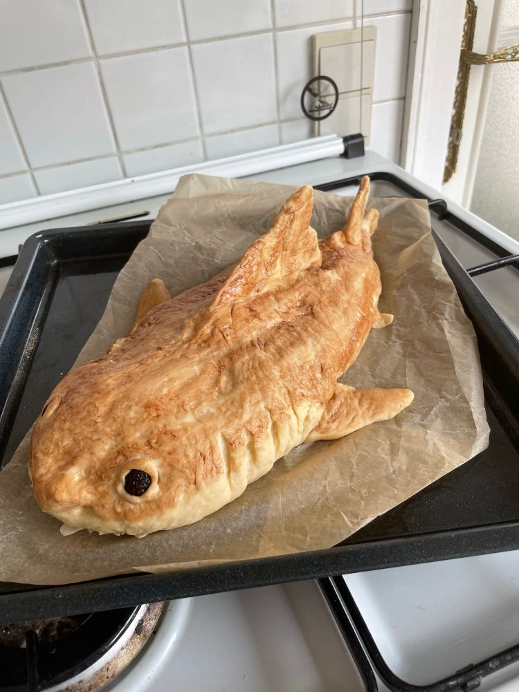 Great white shark shaped bread loaf with cocoa coloring and raisin eyes 