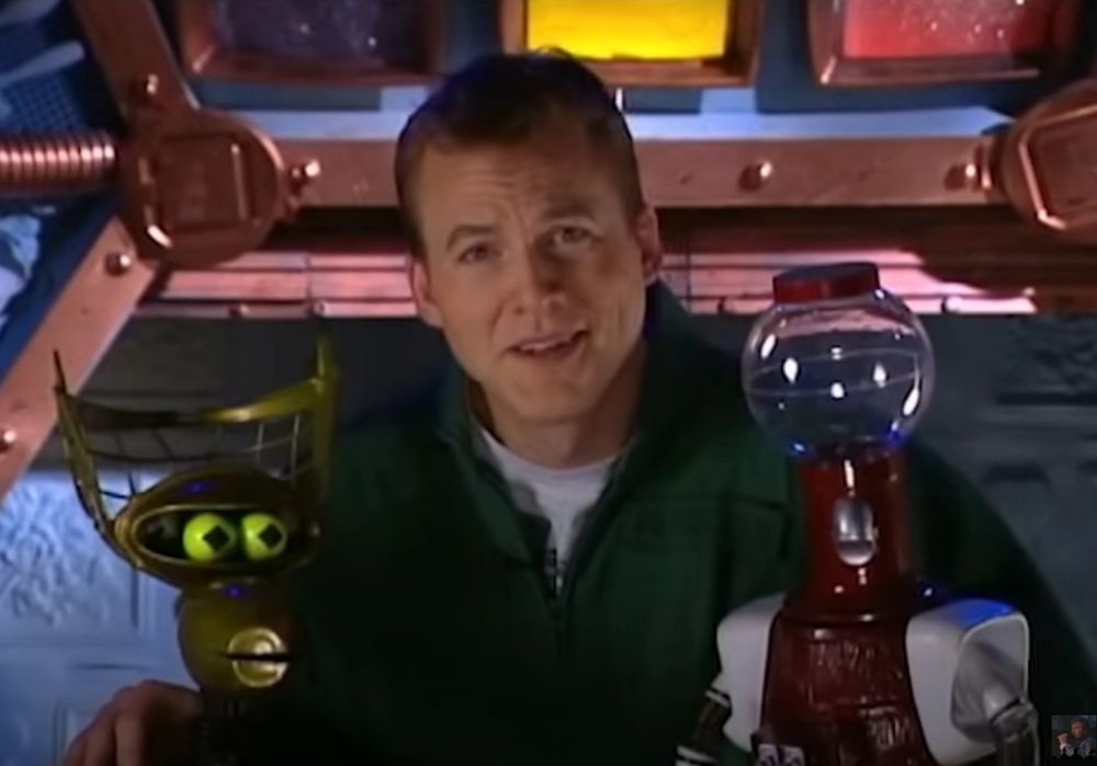 Mike Nelson on the Satellite of Love, palling around with Crow T. Robot and Tom Servo, waiting on Pearl Forrester to reply to, "Well, that sounds GREAT, Pearl. I hope your party is a big success. When does the ball start?", during the early part of "Mystery Science Theater 3000" episode 903, "The Pumaman"