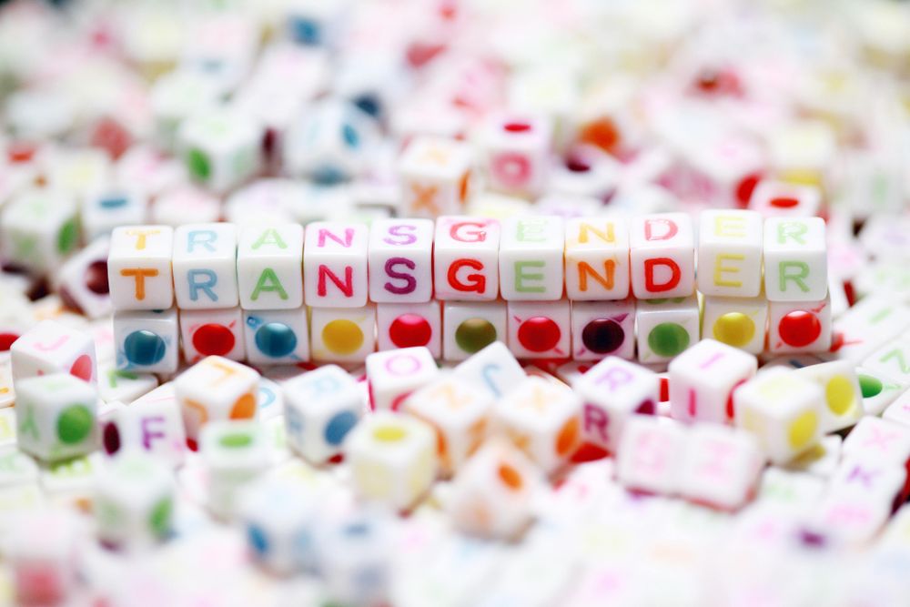 Close-up of colorful letter blocks forming the word transgender, emphasizing gender identity and diversity.
