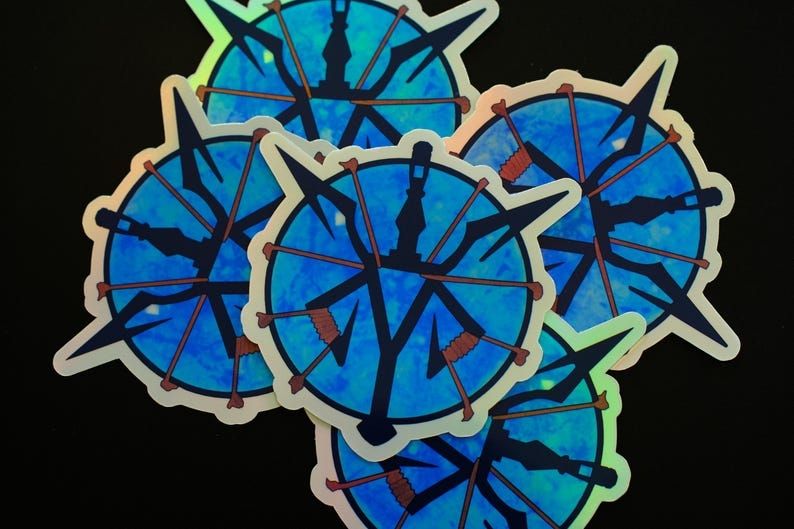Resident evil 4 holographic stickers laying on each other 
They are blue medallions 