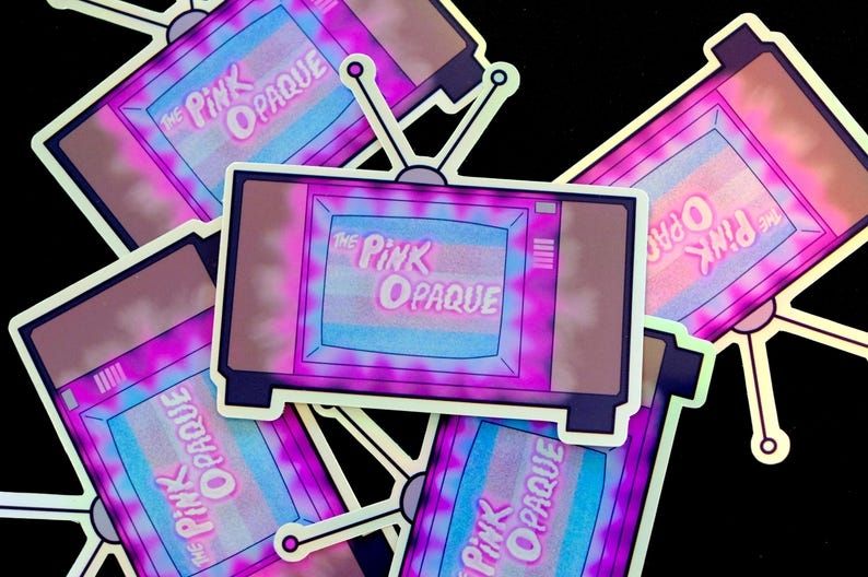 I Saw The TV Glow tv glowing with pink around the words on screen it says Pink Opaque. behind that is the trans flag
many of them are stickers laying on each other