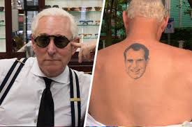 Left: Roger Stone posing with sunglasses and black/white suspenders over a white button down
Right: Richard Spencer having begun to disrobe and reveal a grotesque tattoo of a smiling Richard Nixon placed along his upper vertebrae. 