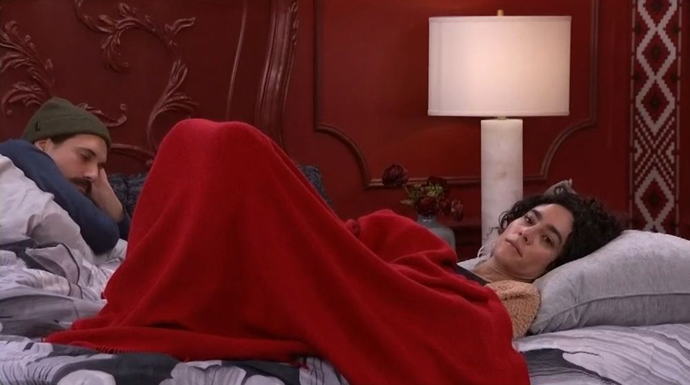 Morgan & Vince in bed with her staring off into space.