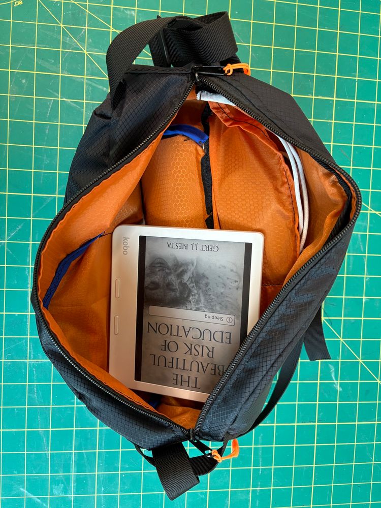 The inside of the bag featuring a kobo and several other things for size
