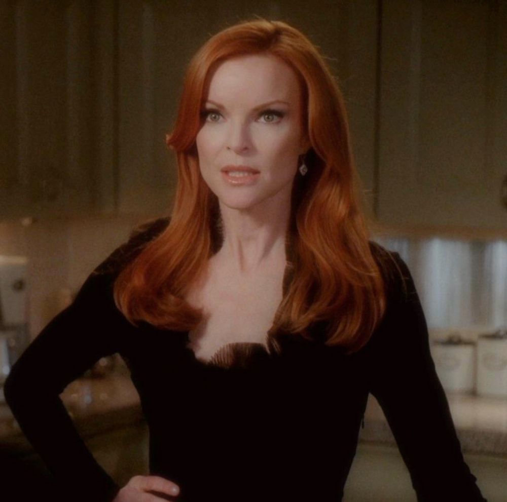 Bree Van de Kamp from Desperate Housewives looking stunning in a black long sleeve shirt with her red hair perfectly cascading down her shoulders and her modelesque visage evoking a slight discontent 