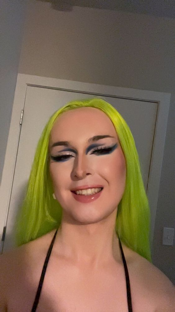 Me in makeup with pink lips and blue cut crease