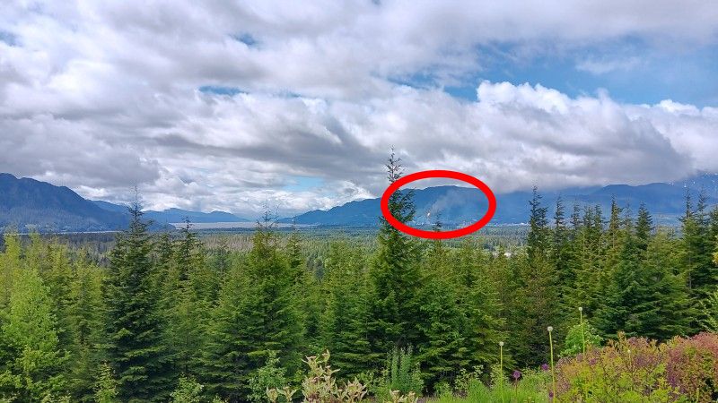 View of LNG Canada facility in Kitimat. Large cloud of black smoke is being emitted by the flare stack and is blowing toward the town.