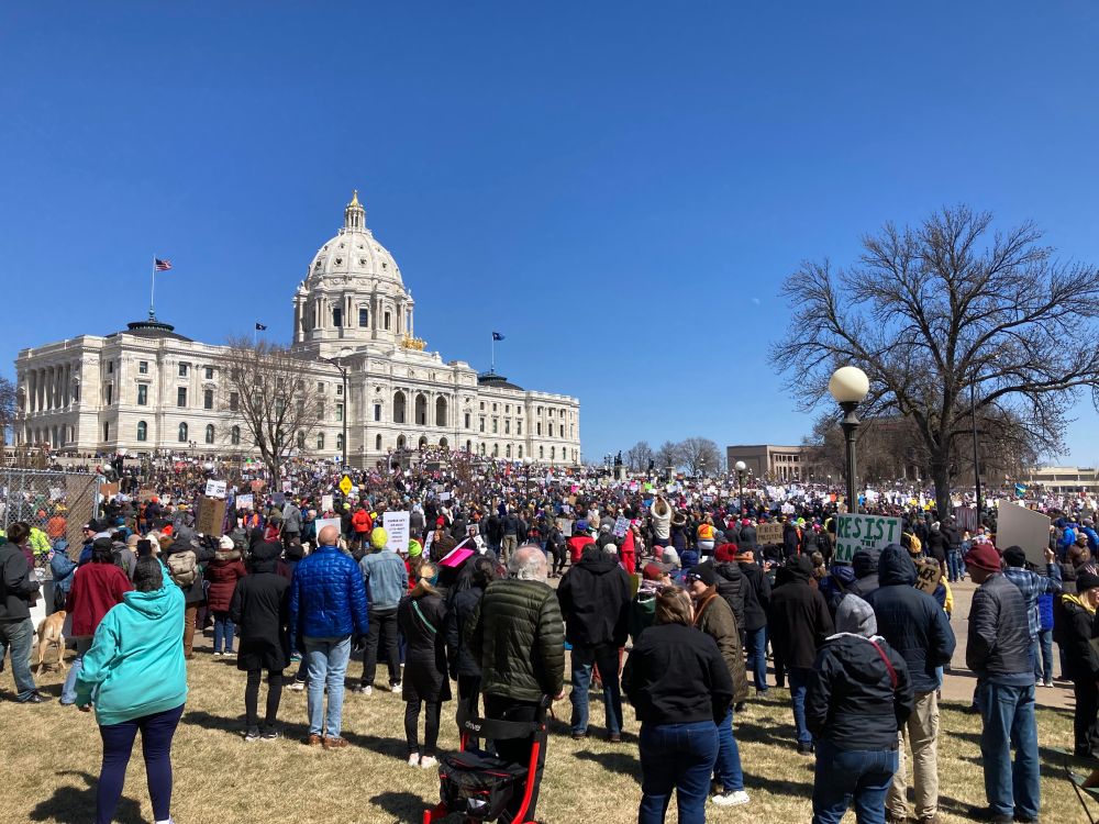 A large crowd protesting in front of the Minnesota state capitol building