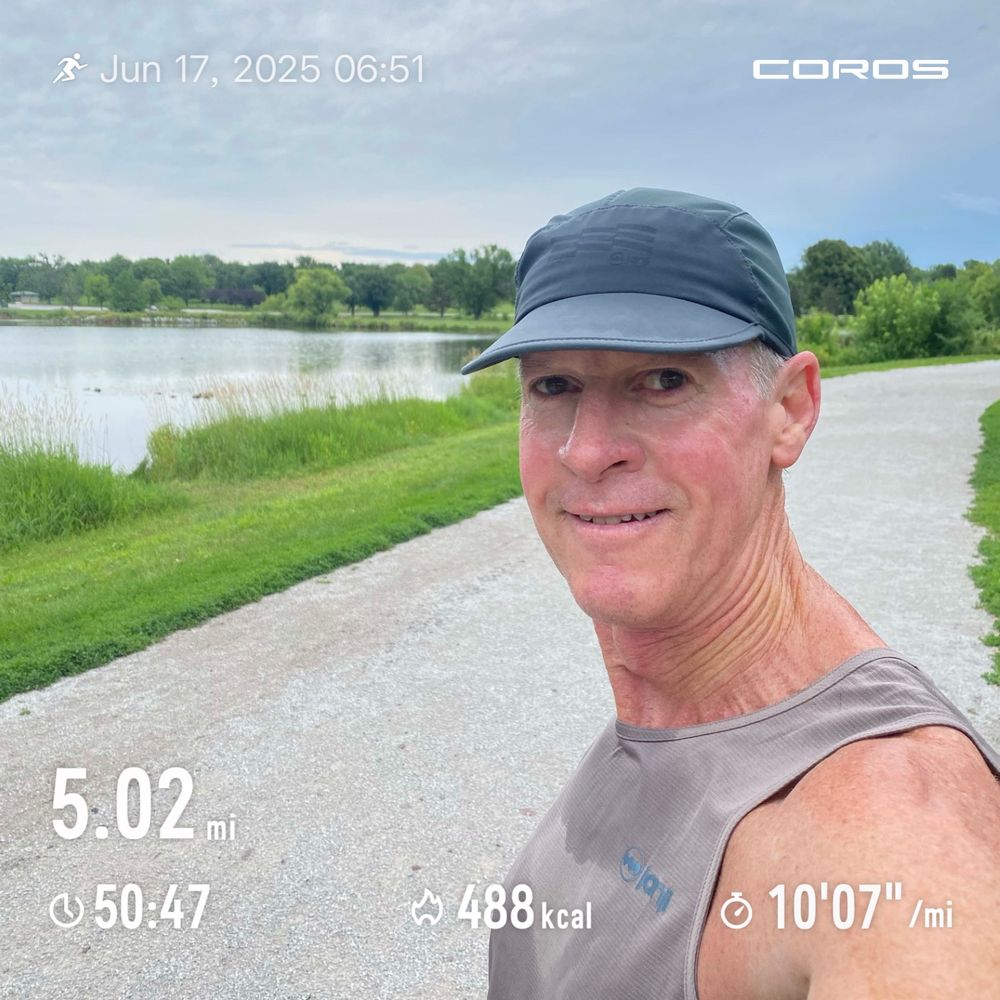Runner posing on chipped limestone trail in front of the local lake. 