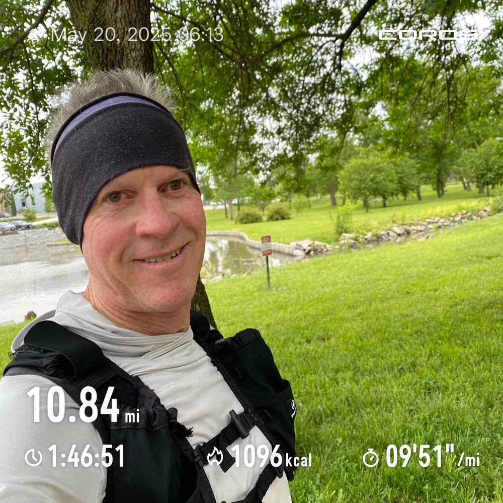 Runner posing by a pond after the running workout. 