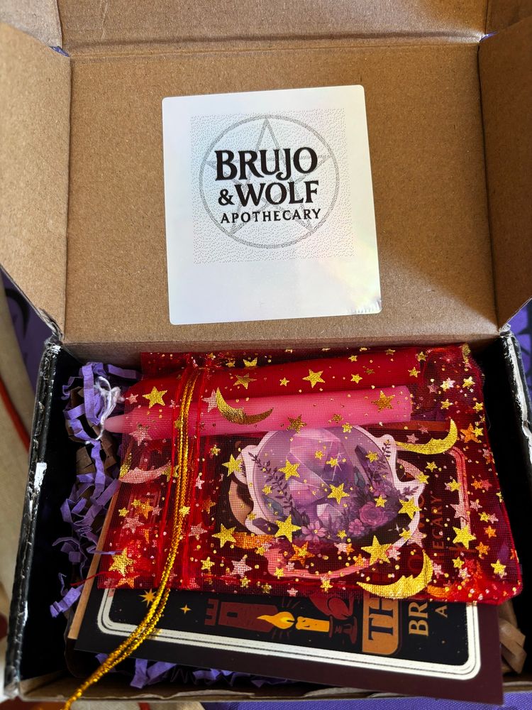 Opened box with chime candles and stickers in a starry bag.