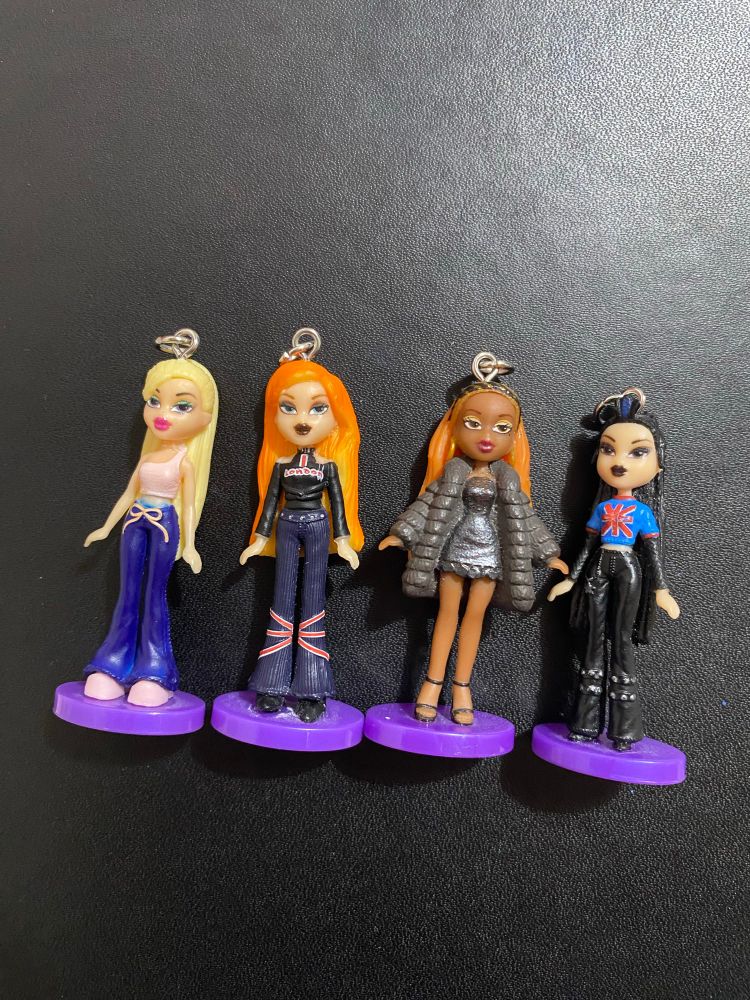 Four mini Bratz doll figures with screw eyes and jump rings attached to their heads to make them into keyrings
