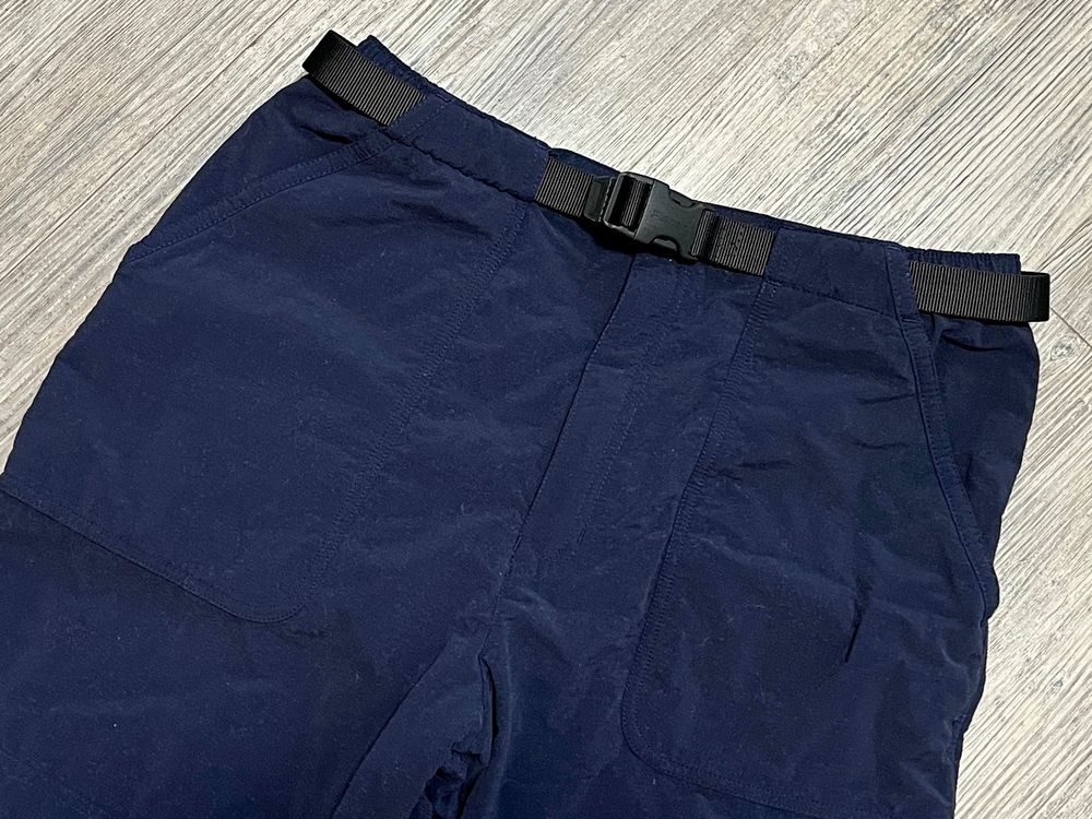 Front pocket and waist detail of a pair of Rohan Icelander fleece-lined trousers laid on a wooden floor.