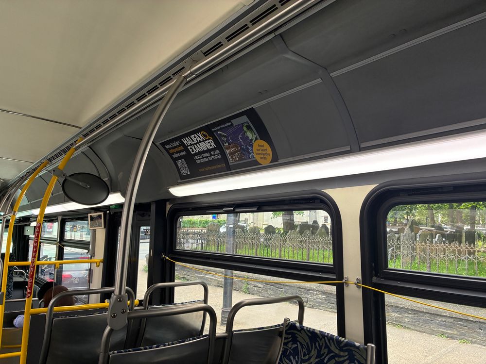 Halifax Transit bus interior photo of a Halifax Examiner advertisement. 