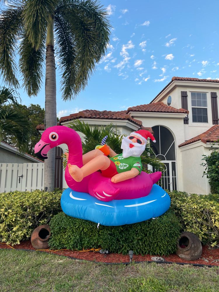 Blow up Hawaiian themed Santa riding a Flamingo