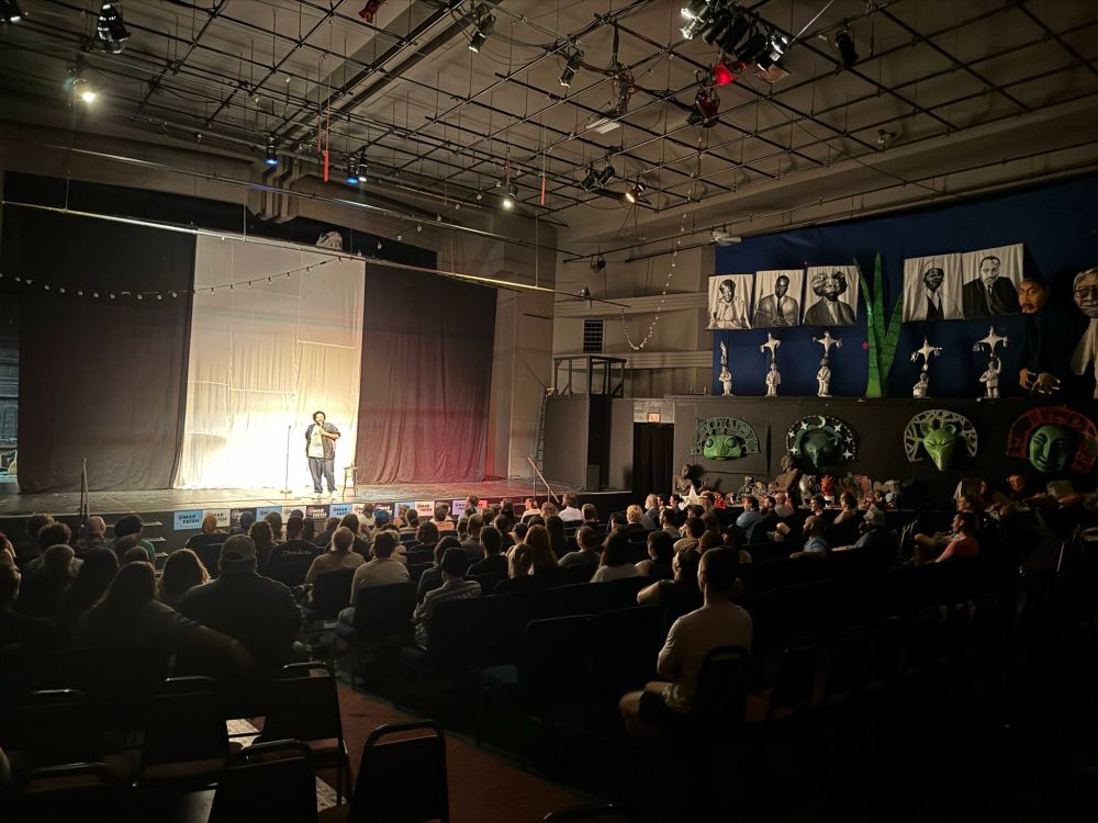 Theater of Omar Fateh supporters watch a stand-up comic