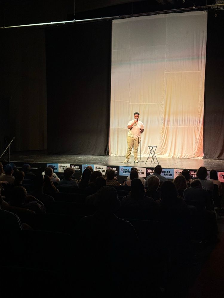Theater of Omar Fateh supporters watch a stand-up comic