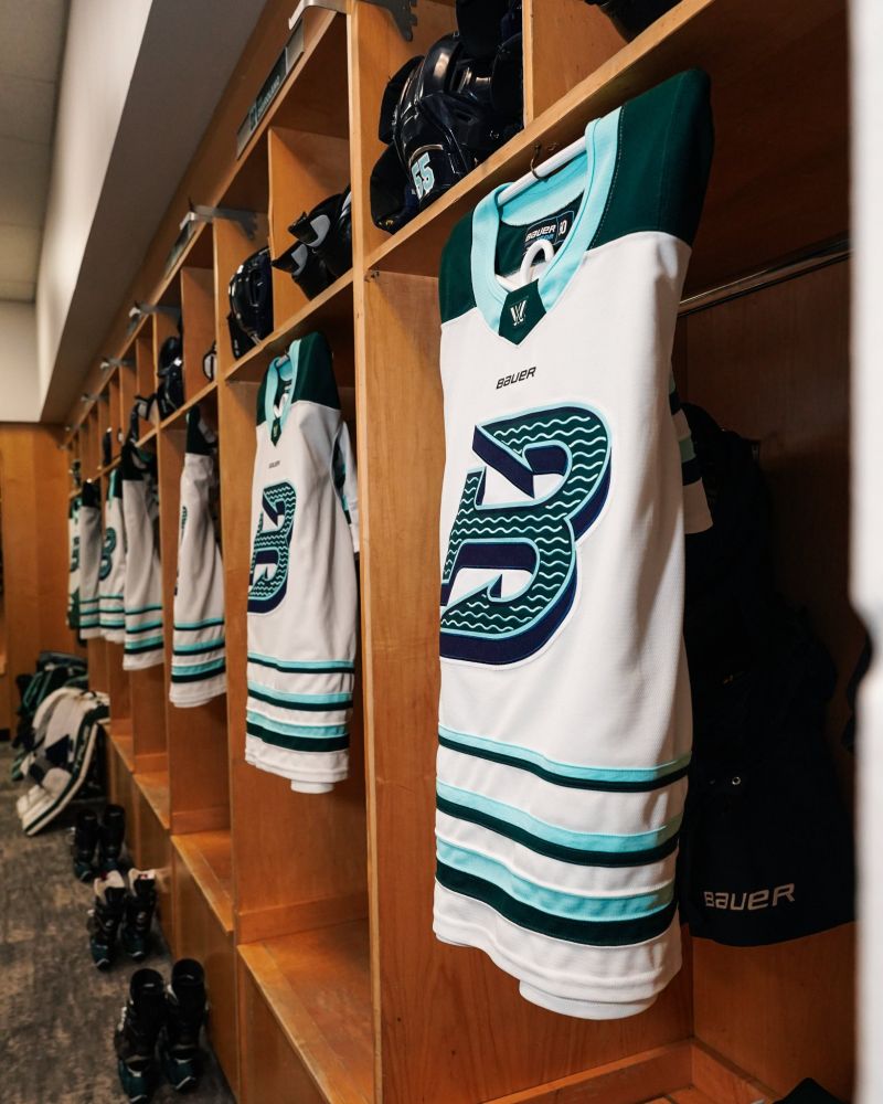 Fleet away jerseys hung up in locker stalls.
