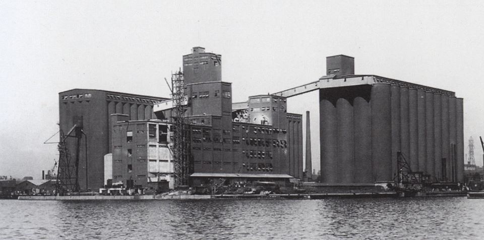 The Toronto Terminal Grain Elevator circa 1930, a large complex of concrete buildings and silos, as seen from Toronto Harbour. Photographer unknown.