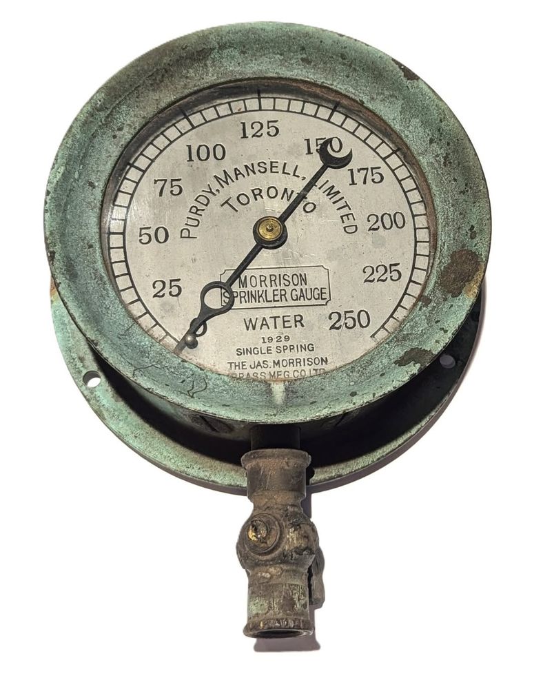 A sprinkler water gauge dating to 1929. It was manufactured in Toronto by the James Morrison Brass Manufacturing Company on Islington Avenue for Purdy-Mansell Limited, a Toronto-based steam fitting and plumbing firm. Though the gauge’s brass housing shows obvious signs of oxidation, it is otherwise in good condition and is complete with its original glass, needle, and valve.