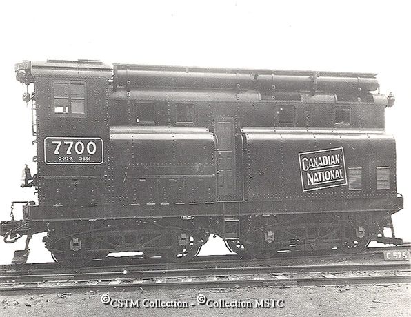 Canadian National Railway diesel locomotive No. 7700, a short, squat black locomotive with a pair of four-wheel trucks and an operator's cab at one end. Canadian Locomotive Company builder's photo, Canada Science and Technology Museum collection.