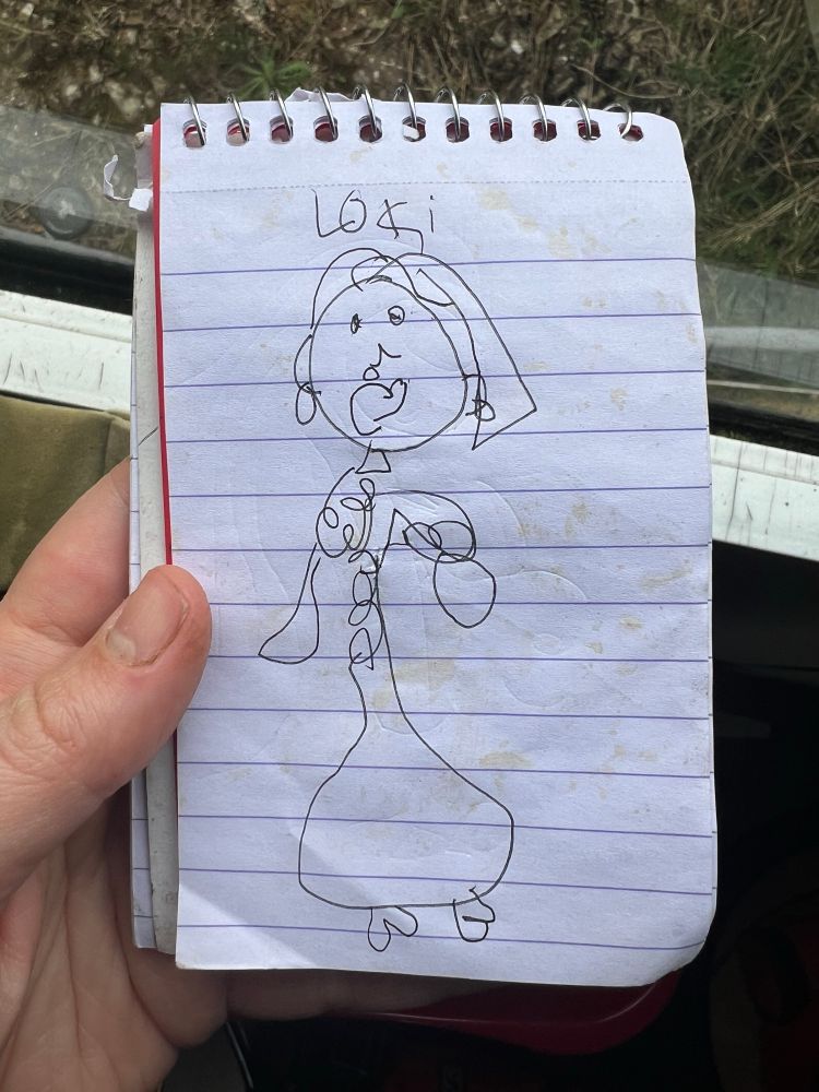 A child’s drawing of a woman with the word “Loki” written above it.