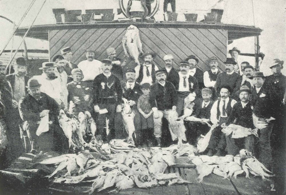 Picture of recreational fishermen gathered around a catch of snapper  (Pagrus/Chrysophrys auratus), southeastern Queensland, Australia. Published in Welsby's 1904 memoir 'Schnappering'.