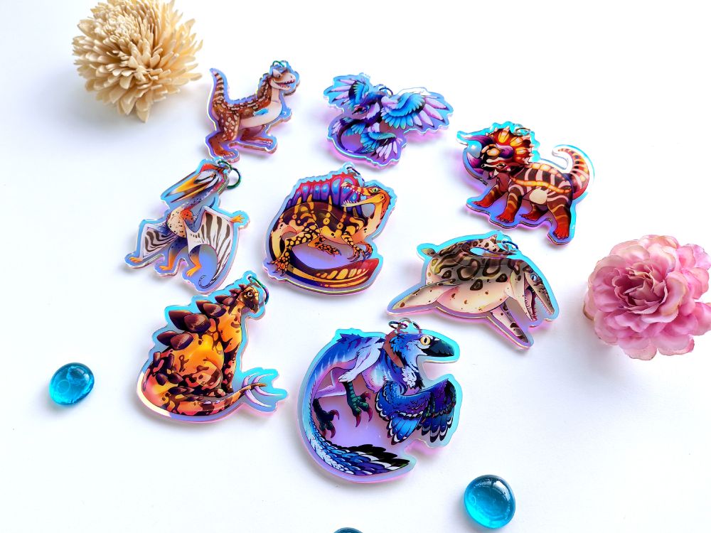 Various charms of dinosaurs. 
▸ Triceratops
▸ Raptor
▸ Spinosaur
▸ Microraptor
▸ Stegosaur
▸ Mosasaur
- Carnotaurus
▸ Quetzacoatlus