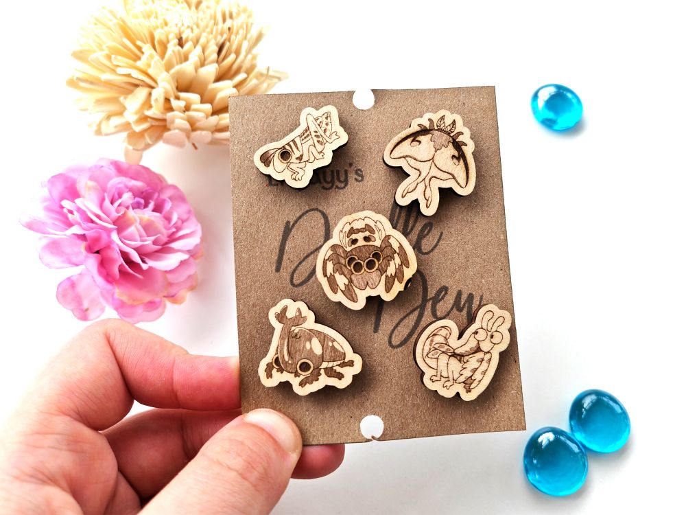 5 wooden engraved bug pins on a kraft paper card featuring a mantis, rhino beetle, spider, grasshopper and moth.