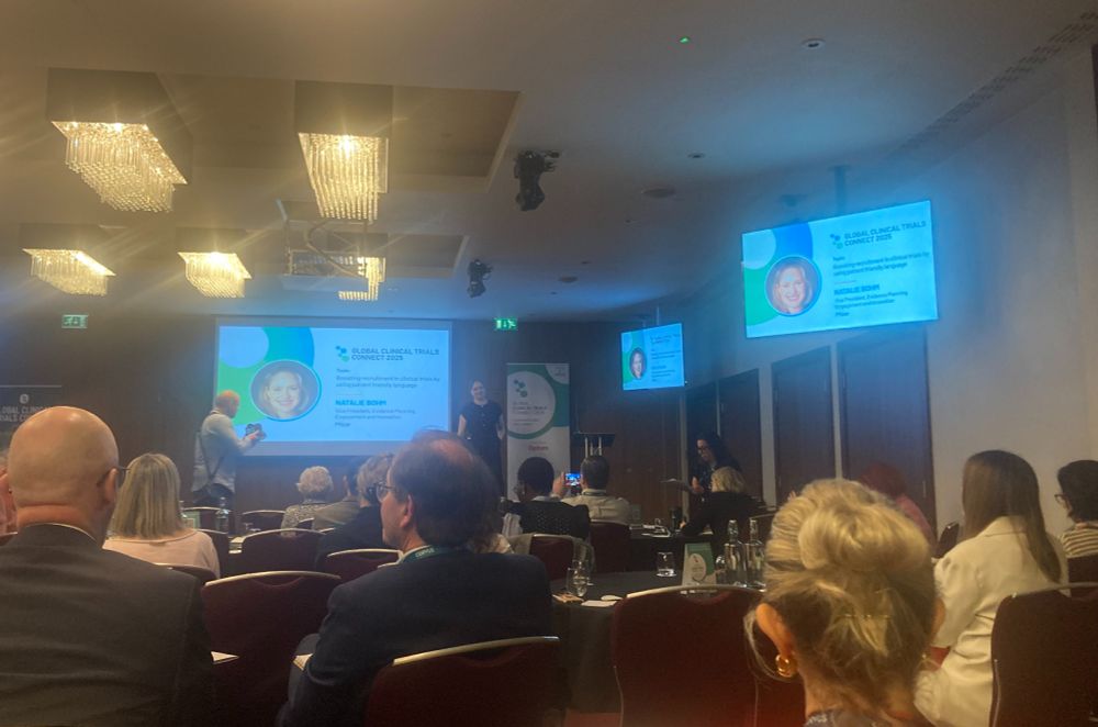 A picture of people sitting down listening to a speaker on stage at the Global Clinical Connect 2025 Conference.