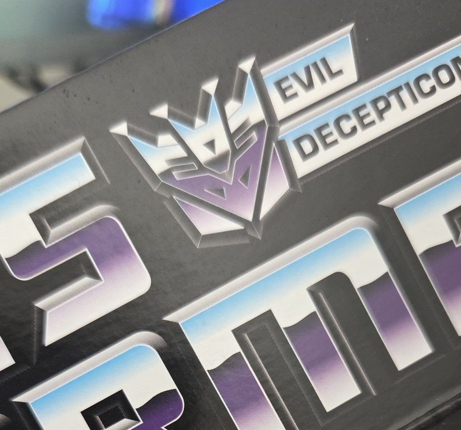 Close up of Decepticon logo on a Soundwave toy box. 