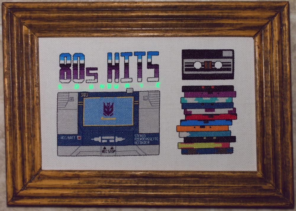 Composite image of the glow for "SOUNDWAVE" onto the image of the cross-stitch to show the location of the word with the rest of it. 