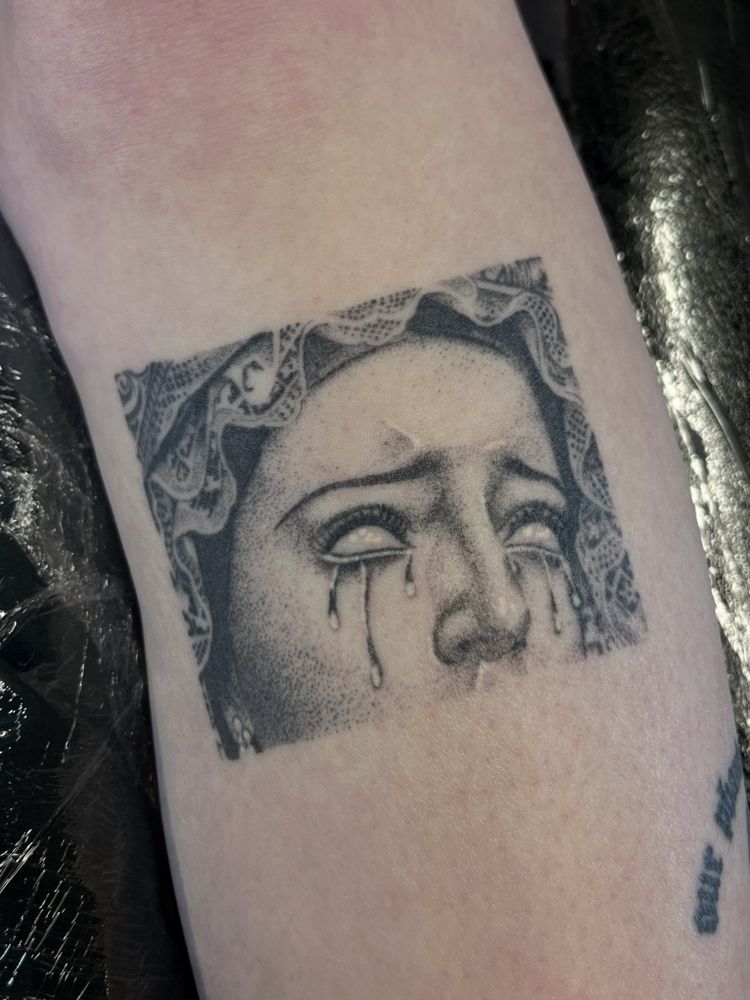 healed dotwork tattoo of a close rectangle cropped lady of sorrows statue