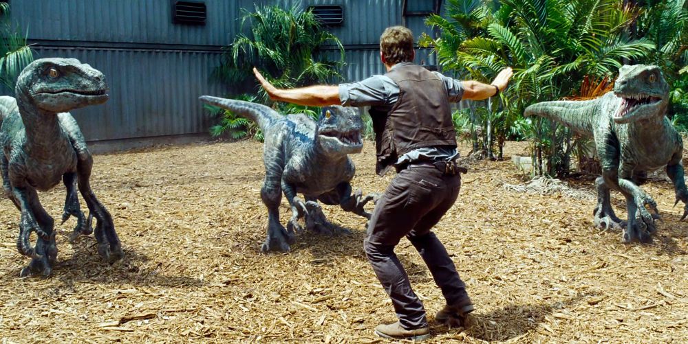 From JURASSIC WORLD:  Chris Pratt as Owen standing off three velociraptors after he accidentally fell into their paddock.