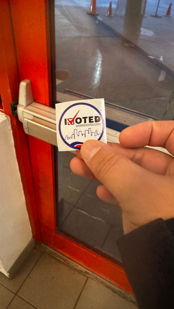 Me holding an I voted sticker 